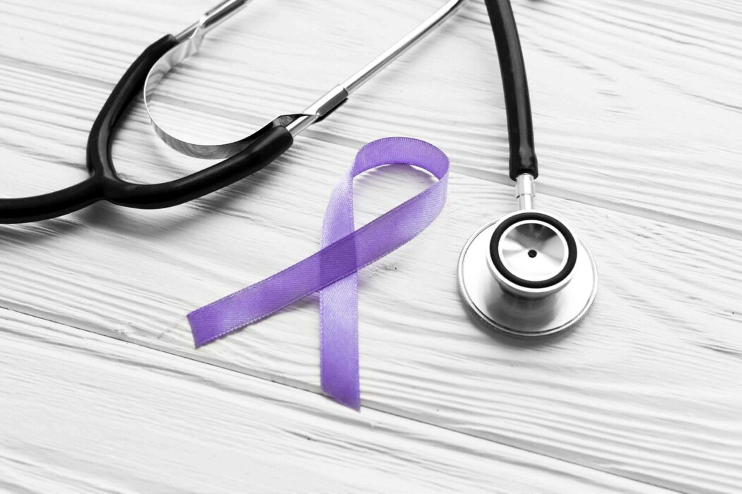 Stethoscope and purple ribbon symbolizing cancer awareness