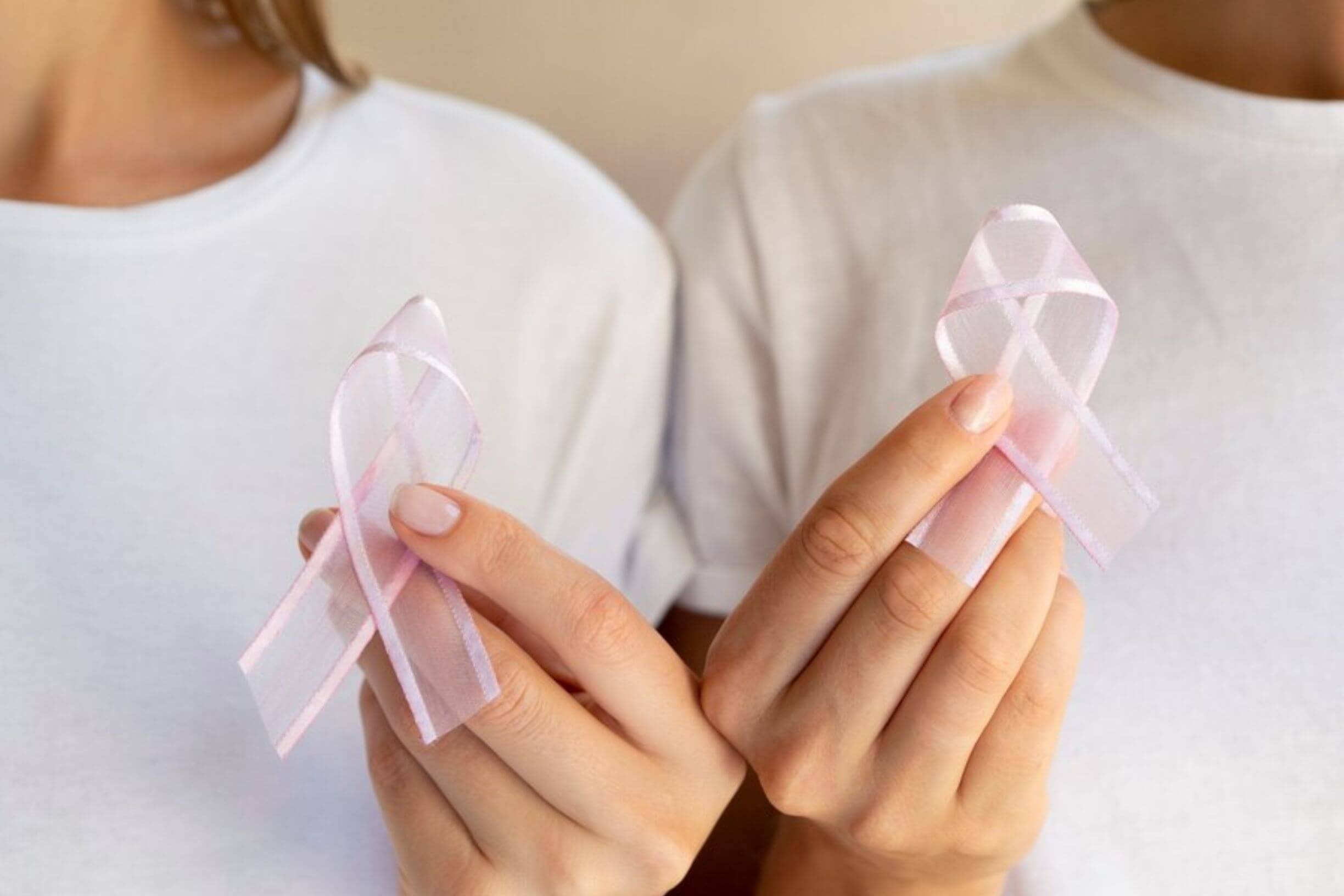 Womans holding up an awareness ribbon for cancer prevention