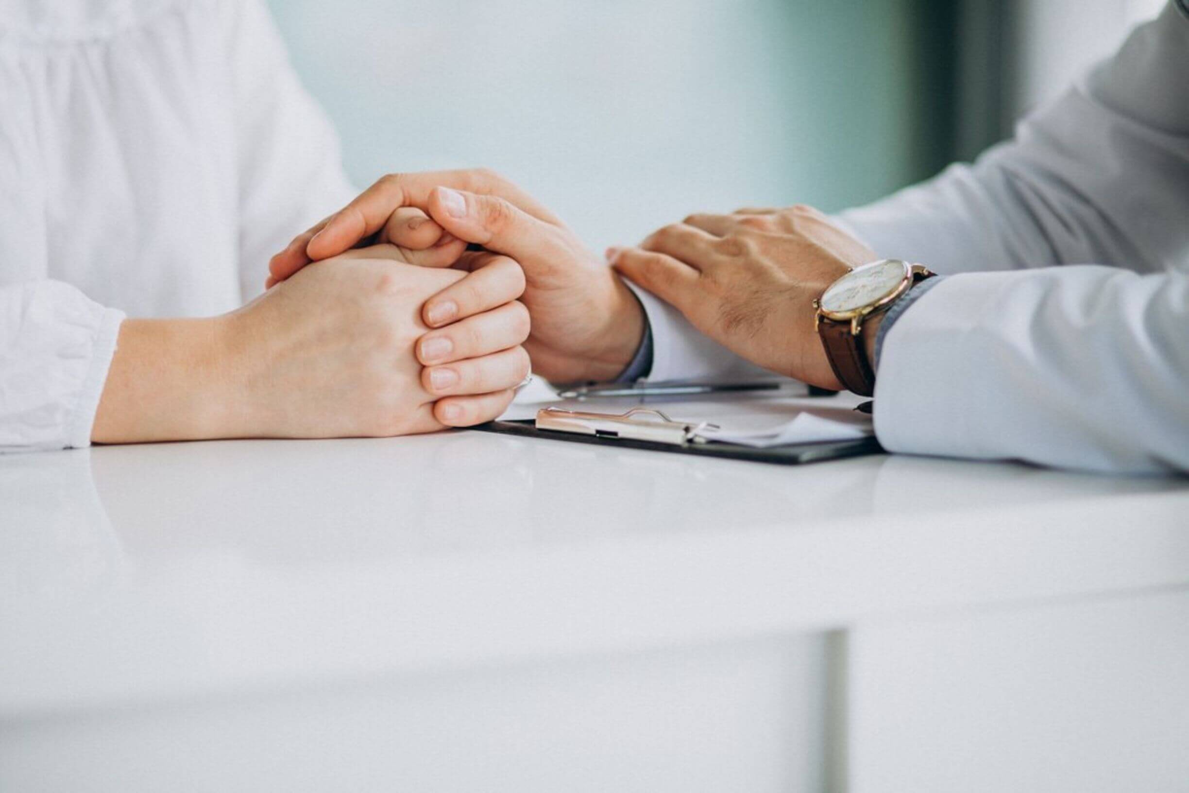 Hands holding each other, symbolizing unity and support in cancer survivorship